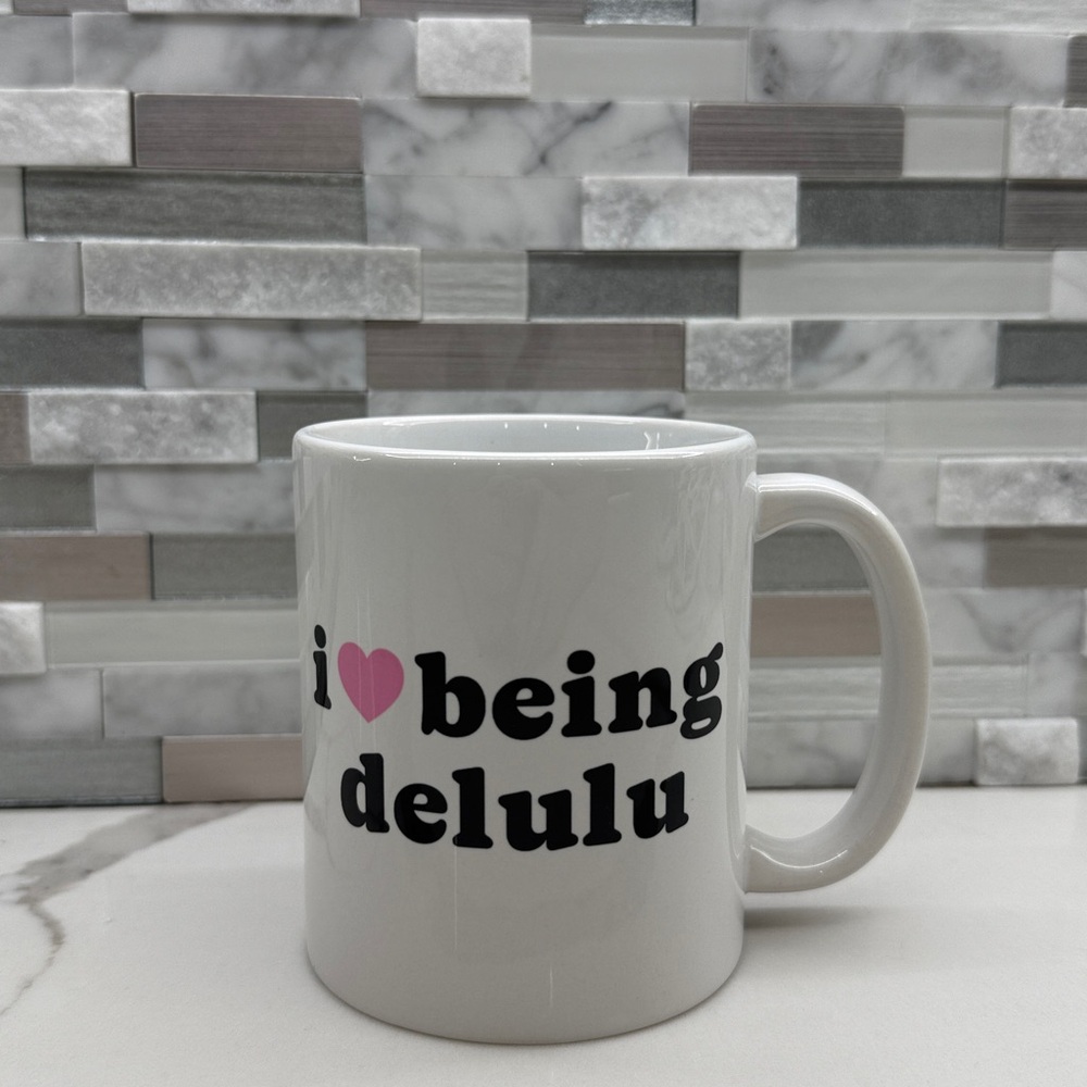 I ❤️ Being Delulu Mug - White Mug with Black and Pink Text